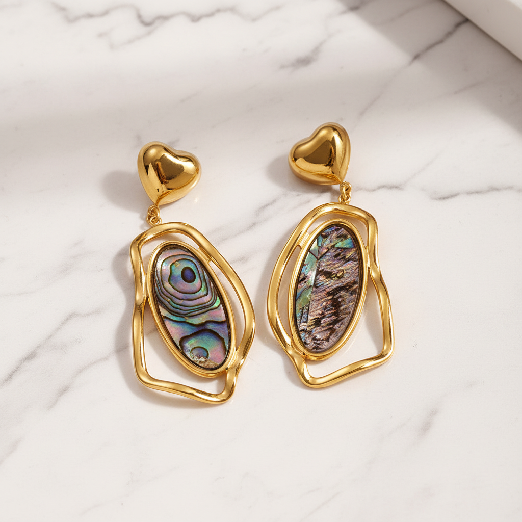 Black earrings on white marble