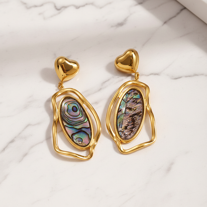 Black earrings on white marble